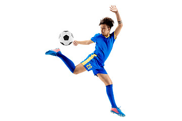 Image showing Young boy with soccer ball doing flying kick