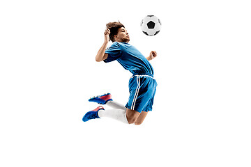 Image showing Young boy with soccer ball doing flying kick