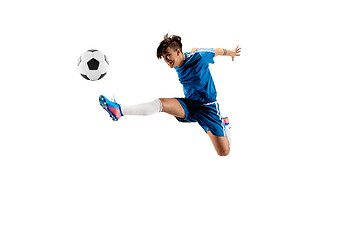 Image showing Young boy with soccer ball doing flying kick