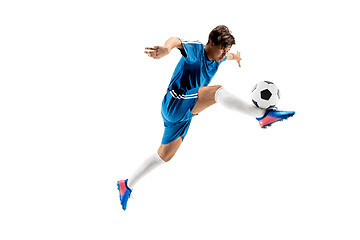 Image showing Young boy with soccer ball doing flying kick