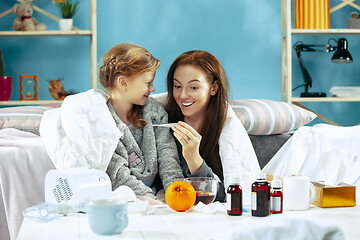 Image showing Sick woman with daughter at home. The ill family.