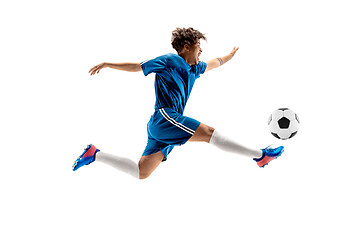 Image showing Young boy with soccer ball doing flying kick