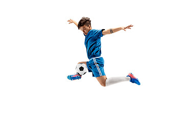 Image showing Young boy with soccer ball doing flying kick