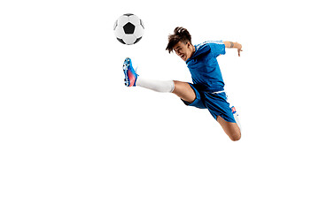 Image showing Young boy with soccer ball doing flying kick