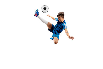 Image showing Young boy with soccer ball doing flying kick