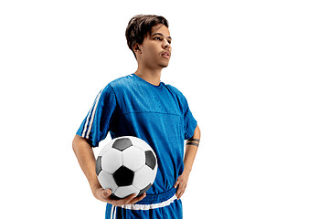 Image showing Young fit boy with soccer ball standing isolated on white