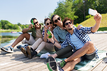 Image showing friends with drinks taking selfie by smartphone