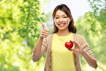 Image showing happy asian woman with red heart showing thumbs up