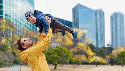 Image showing father with son having fun in autumn tokyo city