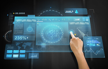 Image showing hand using black interactive panel with charts