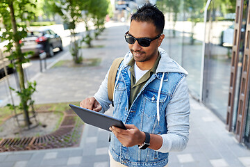 Image showing man with tablet pc and backpack on city street