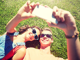 Image showing happy couple taking selfie on smartphone at summer