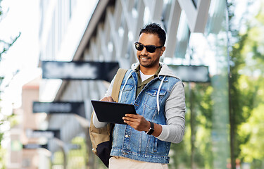 Image showing man with tablet pc and backpack on city street