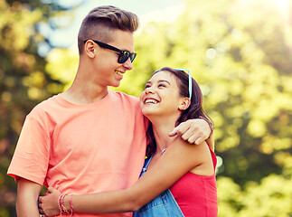 Image showing happy teenage couple looking at each other in park