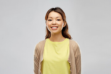 Image showing happy asian woman over grey background