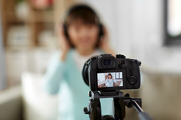 Image showing female blogger with headphones making video blog