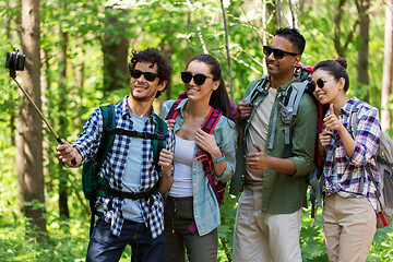 Image showing friends with backpacks hiking and taking selfie