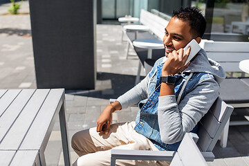 Image showing indian man calling on smartphone at street cafe