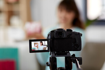 Image showing asian female blogger with gift box recording video