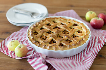 Image showing apple pie in baking mold on wooden table