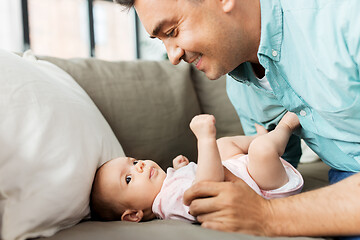 Image showing middle aged father playing with baby at home