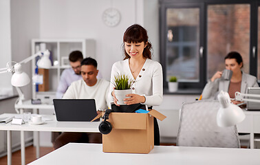 Image showing happy employee with personal stuff at office