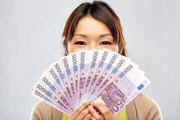 Image showing asian woman with hundreds of euro money banknotes