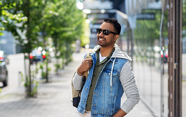 Image showing indian man in sunglasses with backpack in city