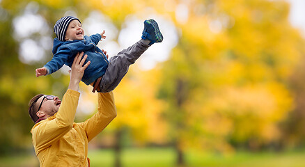 Image showing father with son playing and having fun in autumn