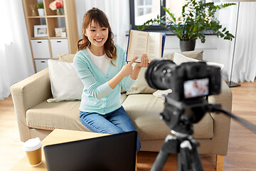 Image showing asian female blogger making video review of book