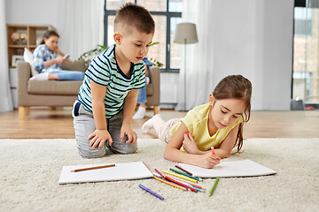 Image showing brother and sister drawing with crayons at home