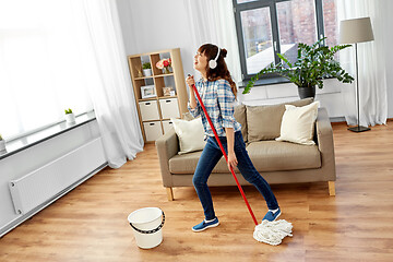 Image showing asian woman or housewife with mop singing at home