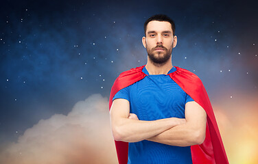 Image showing man in red superhero cape over night sky