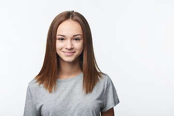 Image showing Smiling relaxed teen girl looking at camera