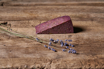 Image showing Lavender cheese with bunch of fresh lavender flowers on rough wooden planks