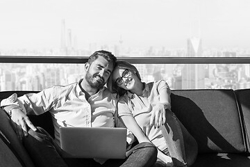 Image showing couple relaxing at  home using laptop computers