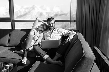 Image showing couple relaxing at  home using laptop computers