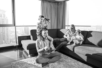 Image showing Happy family playing a video game