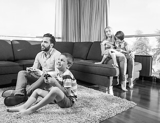 Image showing Happy family playing a video game