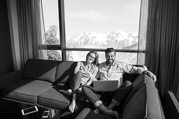 Image showing couple relaxing at  home using laptop computers