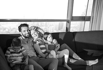 Image showing happy young couple spending time with kids at home