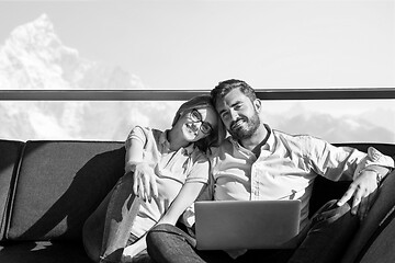 Image showing couple relaxing at  home using laptop computers