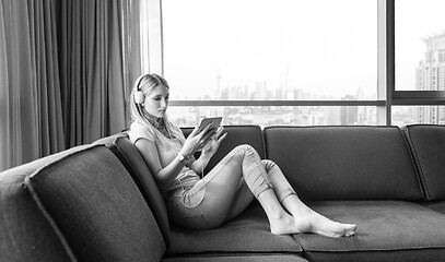 Image showing young girl enjoying music through headphones