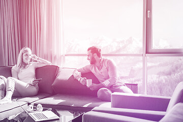 Image showing couple relaxing at  home using tablet computer