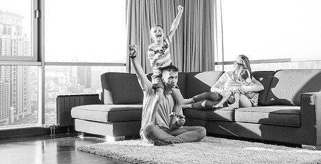 Image showing Happy family playing a video game