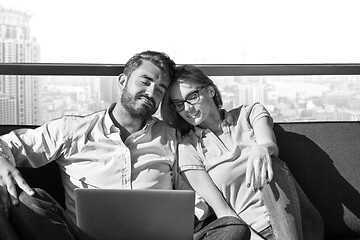 Image showing couple relaxing at  home using laptop computers