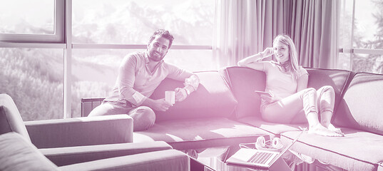 Image showing couple relaxing at  home using tablet computer