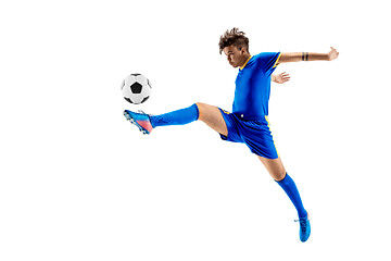 Image showing Young boy with soccer ball doing flying kick