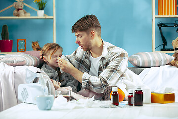 Image showing Sick man with daughter at home. The ill family.