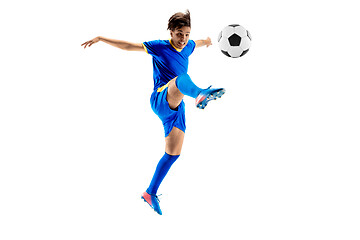 Image showing Young boy with soccer ball doing flying kick